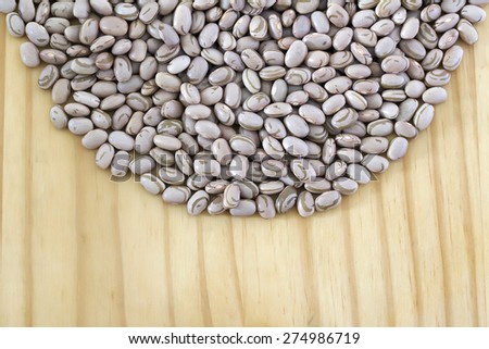 Beans making a round shape over wood table