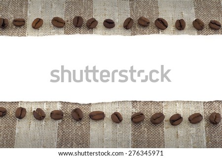 ripped paper crossing over fabric and strategically placed coffee grains around it