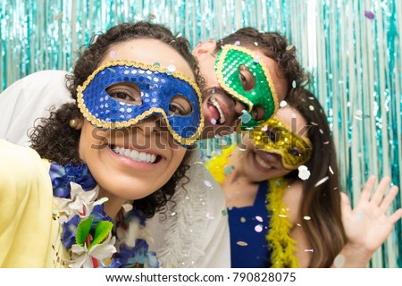 Multi ethnic group of friends is wearing Carnaval masks. Happiness and euphoria. Great party of revelers, all smiling.
