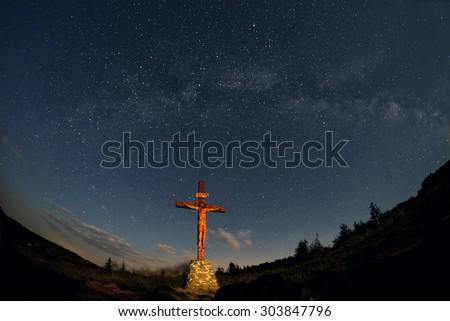 A cross under milky way in Ceahlau mountain