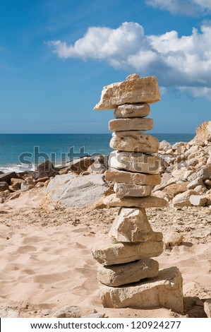 Rock stones on a Portuguese beach stacked as a tower in balance