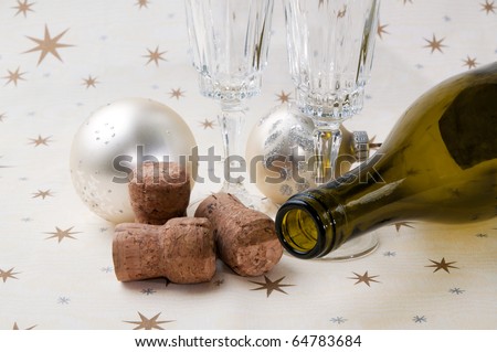 Ten past twelve: empty bottle with empty glasses, tree corks and christmas balls