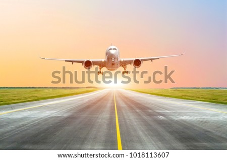 Large passenger plane take off from the runway before the light from the sunshine