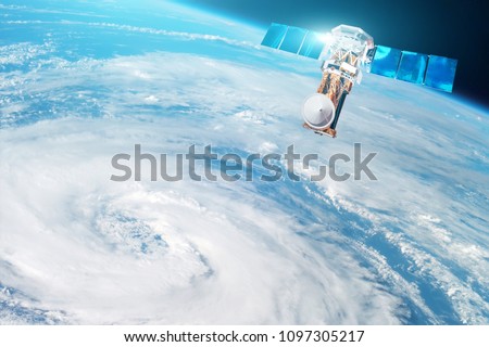 Research, probing, monitoring of tracking in a tropical storm zone, a hurricane. Satellite above the Earth makes measurements of the weather parameters. Elements of this image furnished by NASA