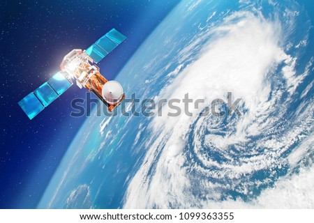 Satellite above the Earth makes measurements of the weather parameters. Research, probing, monitoring of tracking in a tropical storm zone, a hurricane. Elements of this image furnished by NASA