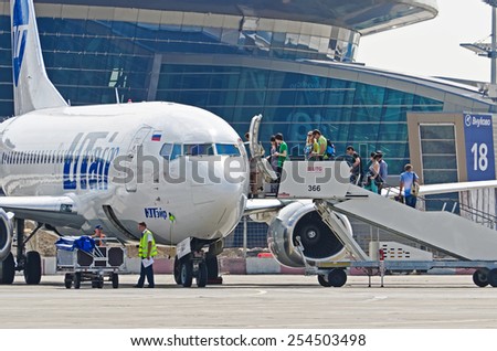 Passengers boarding at the airport boeing 737, Utair, Airport Vnukovo, Russia Moscow, 02 July 2013