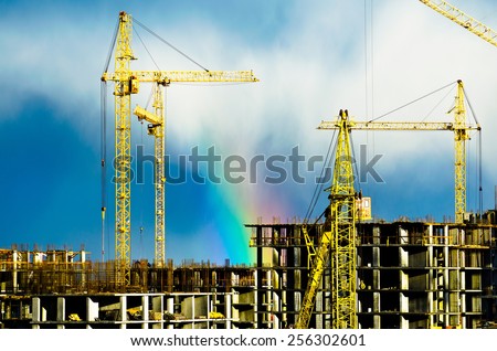 Construction cranes industrial city rain rainbow 01