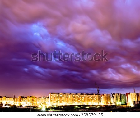 Purple sky storm industrial city lights night
