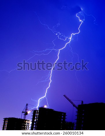 Lightning storm crane weather industrial city building construction night flash