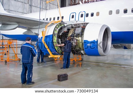 Replacing the engine on the airplane, working people. Concept maintenance of aircraft