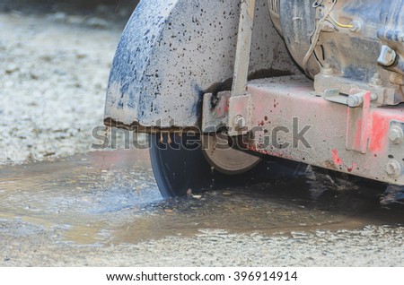 Cutting concrete machine in action at reconstruction area.Closeup shoot.