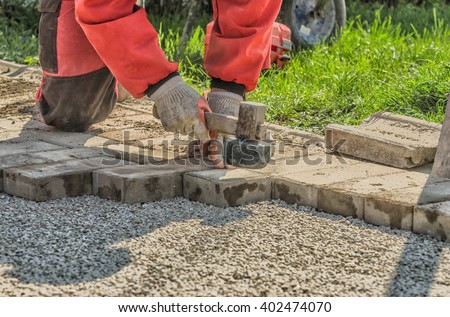 Worker paving a walkway