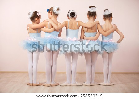 Group of five little ballerinas posing together with back to camera. They are good friend and amazing dance performers