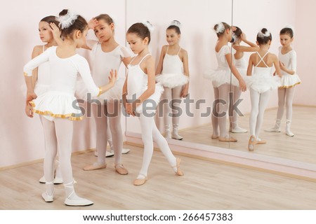Group of six little ballerinas posing together and practicing for performance. They are good friend and amazing dance performers