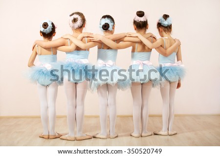 Group of five little ballerinas posing together with back to camera. They are good friend and amazing dance performers