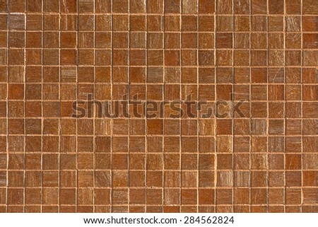 old tile wall is color golden brown.