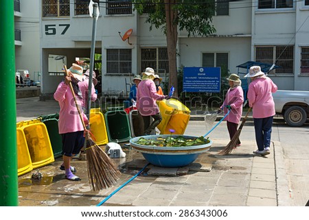NONTHABURI THAILAND-MAY 26: women workers clean up trash in the village for good health of the people in the village may 26,2015 at Bangbourthong village Thailand