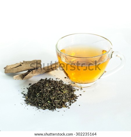 Indian black tea and cup of black tea with wooden stick on a white background