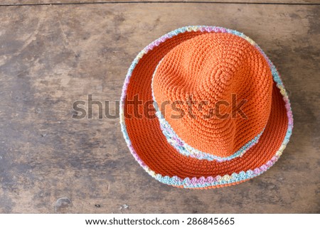 Woman summer orange straw hat on wood background