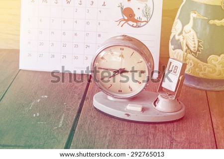 Vintage clock on wooden table , vintage style