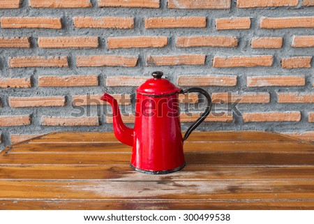 Red kettle on wood table