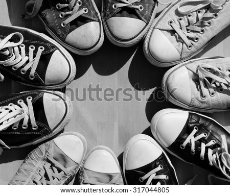 Black and white sneakers standing in the circle, view from above