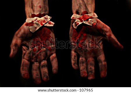 Spooky bleeding hands with bandaids covering up the wounds.