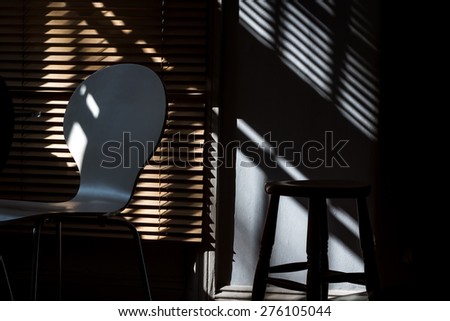 Chair, stool, blinds and shadows
