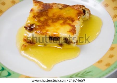 plate with baked pudding and honey