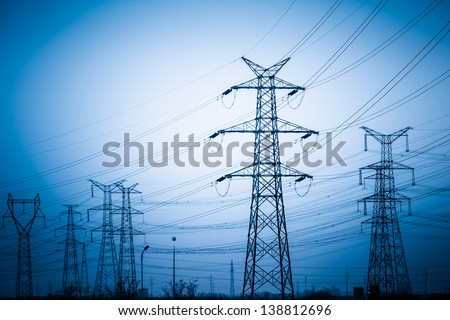 High voltage towers with sky background. blue toned images.