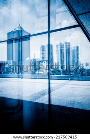 Reflection of modern office building on the glass of window outdoor in shanghai china.
