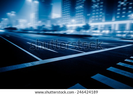 speeding lights of cars in city at night.