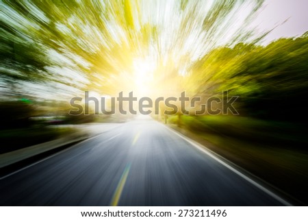 Road in motion blurÃ?Â¯Ã?Â¼? through the forest in sunset.