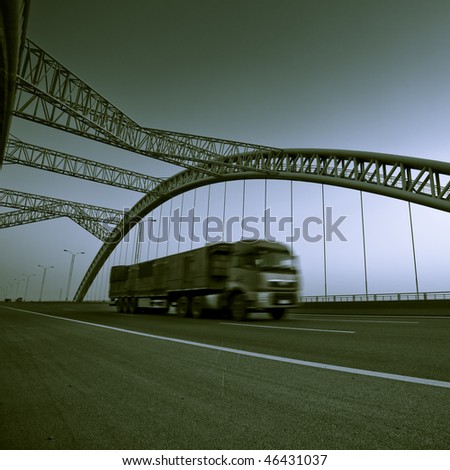 truck speeding through a bridge at sunset,motion blur.