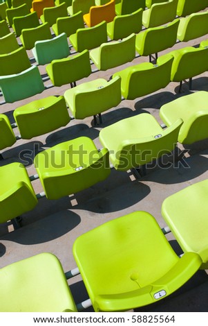 A field of empty seats in a open stadium in china outdoor.