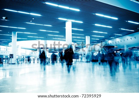 clean tiled floor, reflection of light on floor and blurred view of people walking