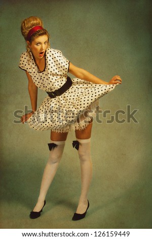 Pretty woman pin up style woman in vintage red dress and stockings.  Portrait in pin-up retro style. Stock Photo