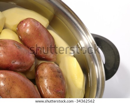 Fresh raw potatoes into the steel pan. Is not isolated image
