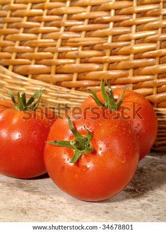 Fresh ripe tomatoes with water drops on the table