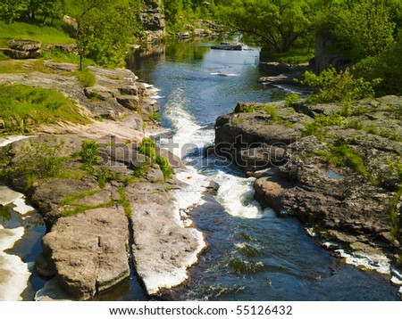Mountain river flowing in the rocks. Summer landscape