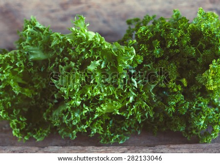 Letucce salad leaves on wooden background. Healthy food illustration. Salad ingridient closeup.
