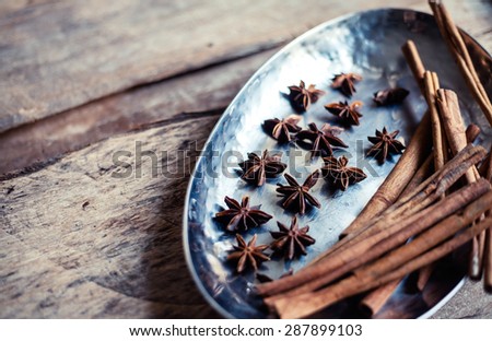 Cinnamon and star anise seeds on a wooden background with shallow depth of field. Bright still life photo of spices.