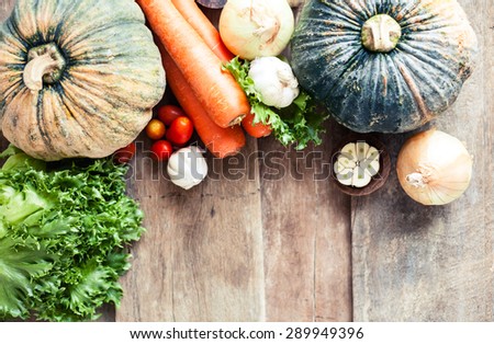 Farm market photo with different vegetables and greens - view from the top. Organic products and healthy lifestyle photography. Fresh food on the wooden background.
