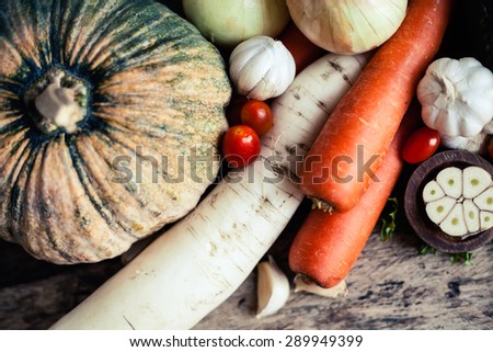 Farm market photo with different vegetables and greens - shallow depth of field. Organic products and healthy lifestyle photography. Fresh food on the wooden background.