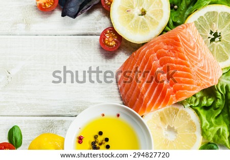 Concept photo of fresh raw salmon fillet on wooden rustic table with place for your text. Top view seafood photo. Healthy food, diet or cooking concept.