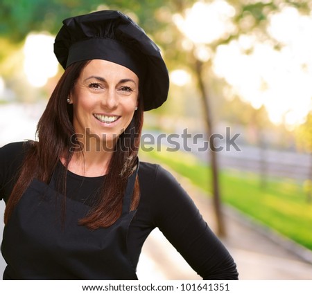 Middle aged cook woman smiling at park
