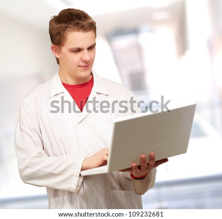 Portrait of a doctor surfing on laptop, indoor