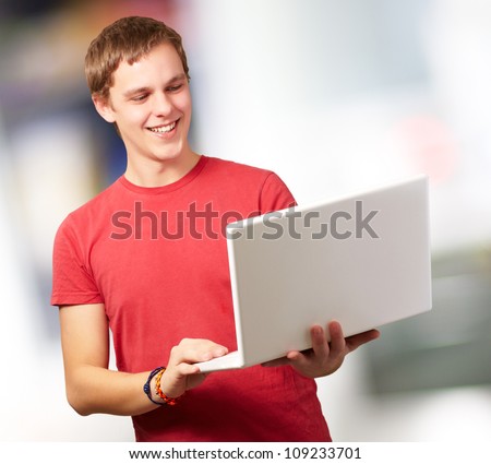Happy man using laptop, indoor