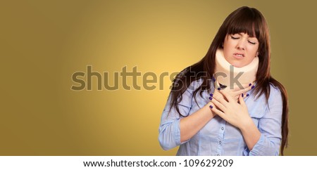 Woman Wearing Neck brace Isolated On Colour Background