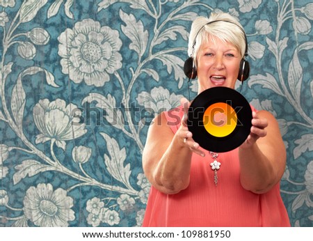 Portrait Of A Senior Woman Holding A Disc On Wallpaper